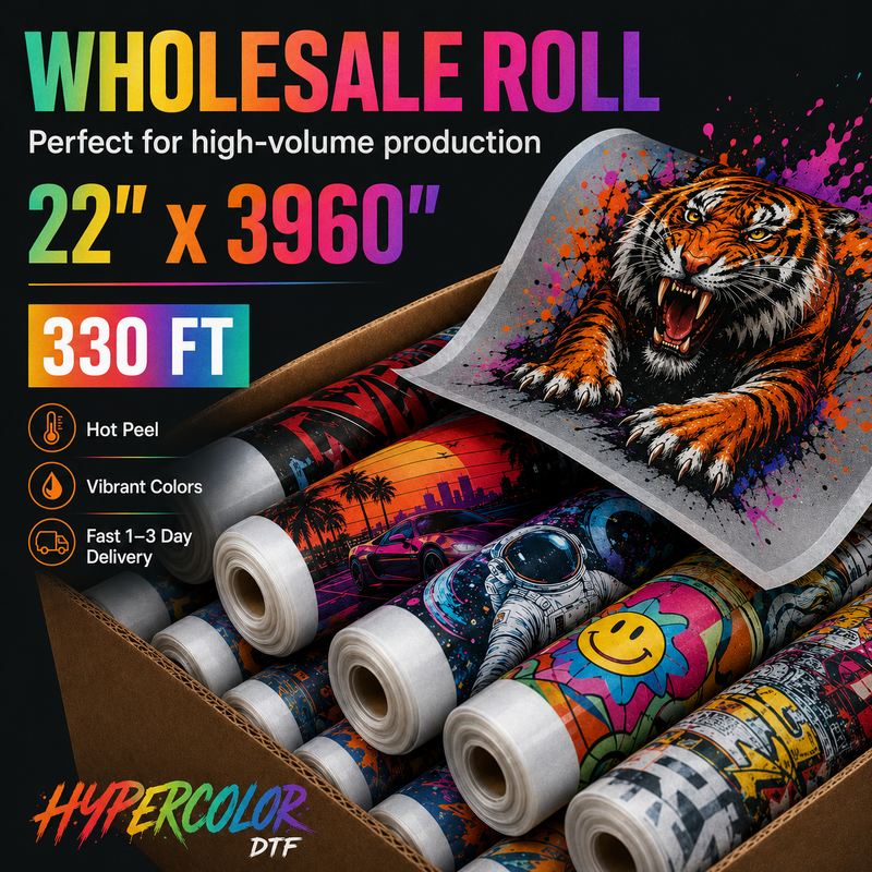 Load image into Gallery viewer, A wholesale roll of DTF transfer paper displayed in a box with multiple printed rolls underneath. The main roll is partially unrolled to show a vivid graphic of a roaring tiger with colorful paint splatters.